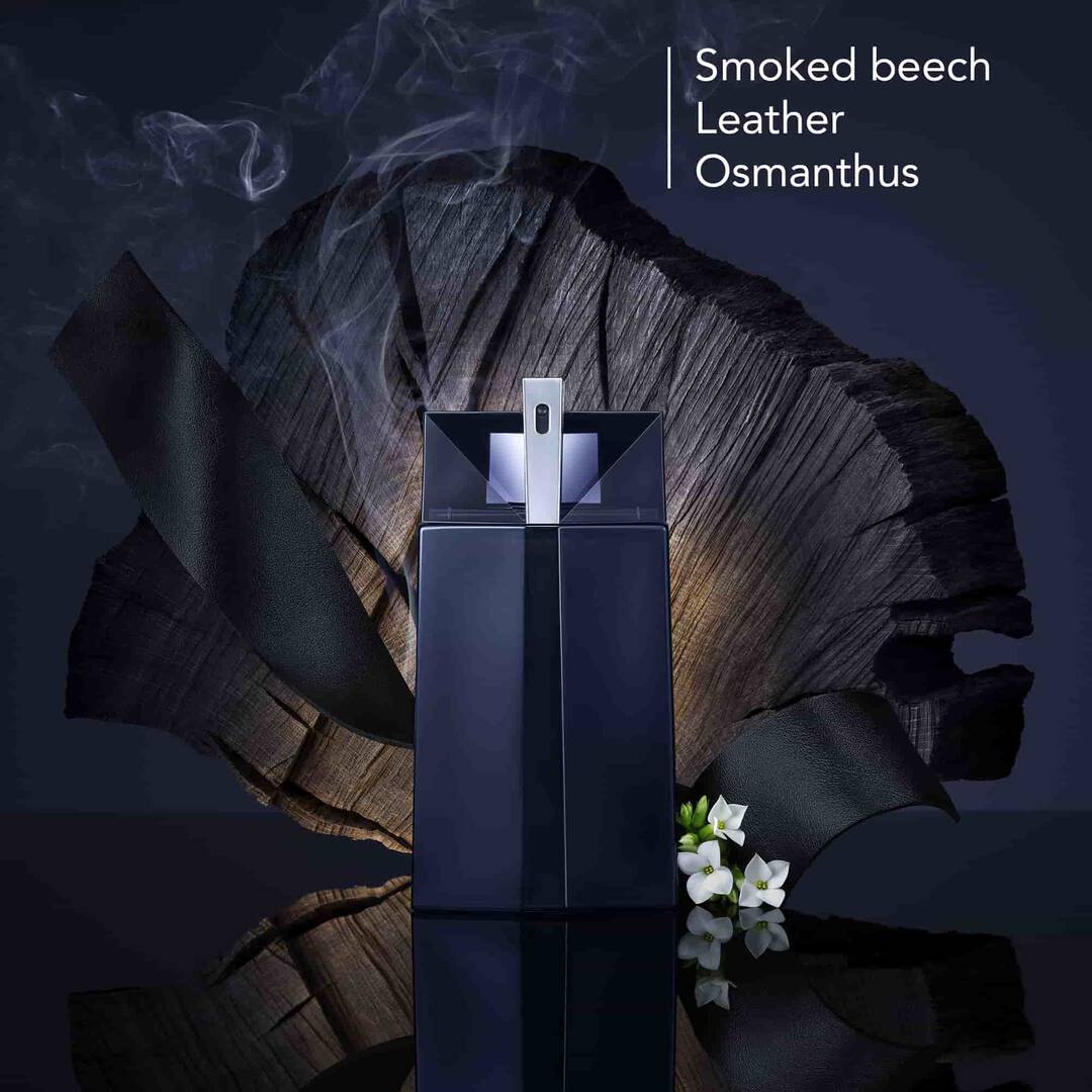 Dark blue rectangular perfume bottle with a central vertical line, an angled geometric top, and a silver-toned sprayer.