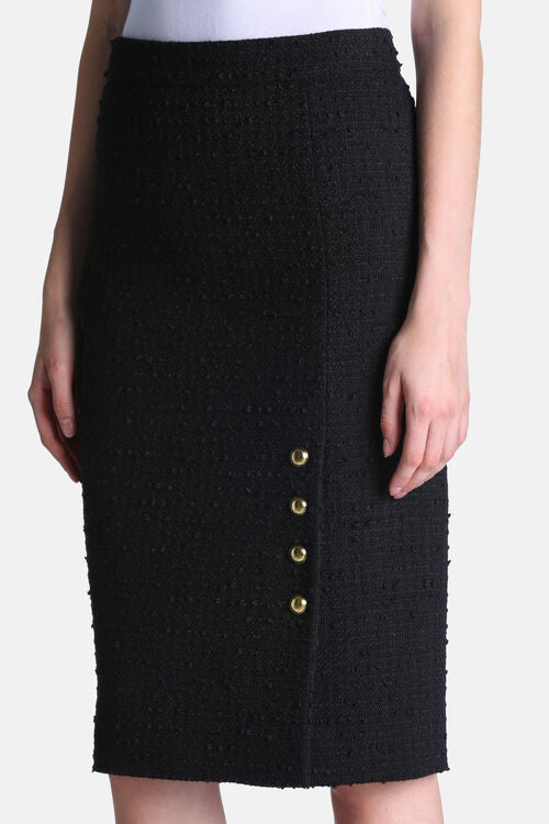 Black textured high-waist pencil skirt with four gold-toned buttons vertically aligned on the left side of a front slit.