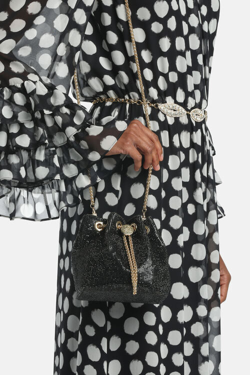 Black bucket bag with a shimmering mesh texture, gold-toned chain drawstring, emblem, and a long gold-toned chain strap.