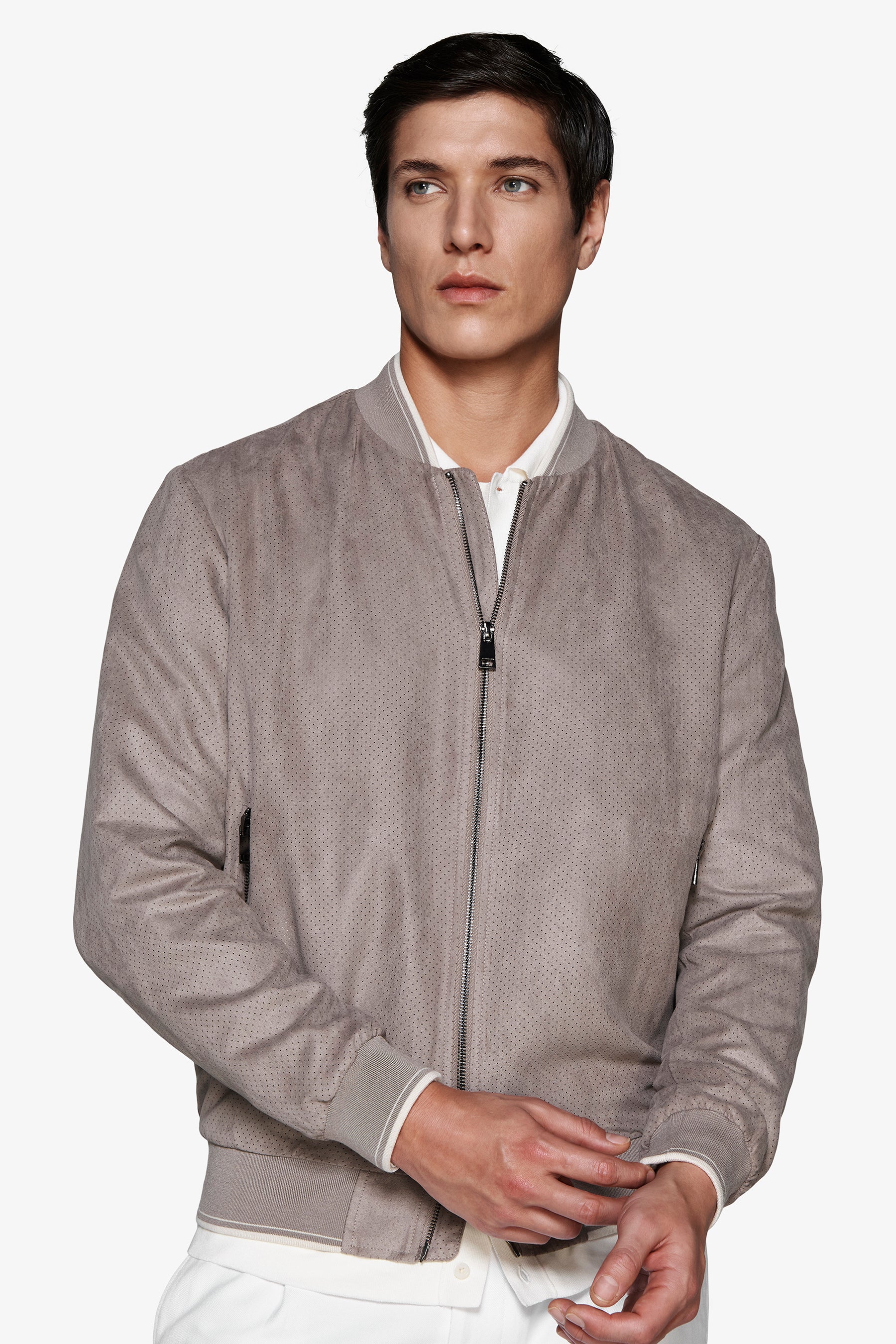 Taupe perforated suede bomber jacket with full-zip front, ribbed collar, cuffs, and hem with white stripe detail.