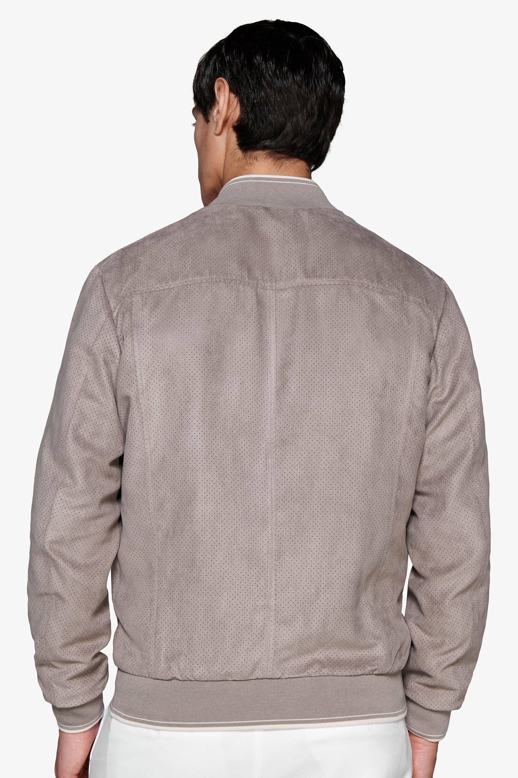 Taupe perforated suede bomber jacket with ribbed collar, cuffs, and hem, each featuring a thin white stripe.