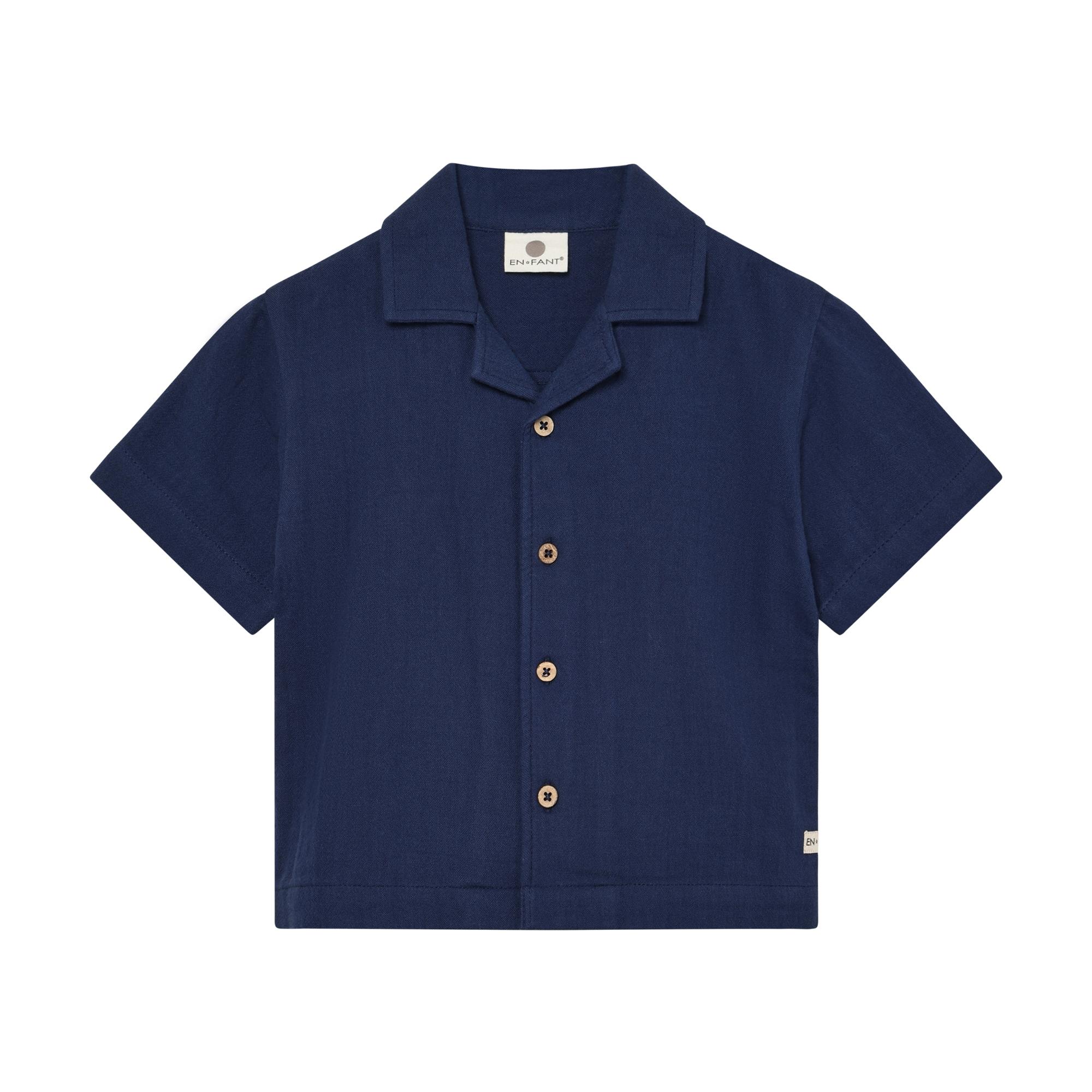 Navy blue muslin short sleeve shirt for kids with a revere collar and light brown buttons.