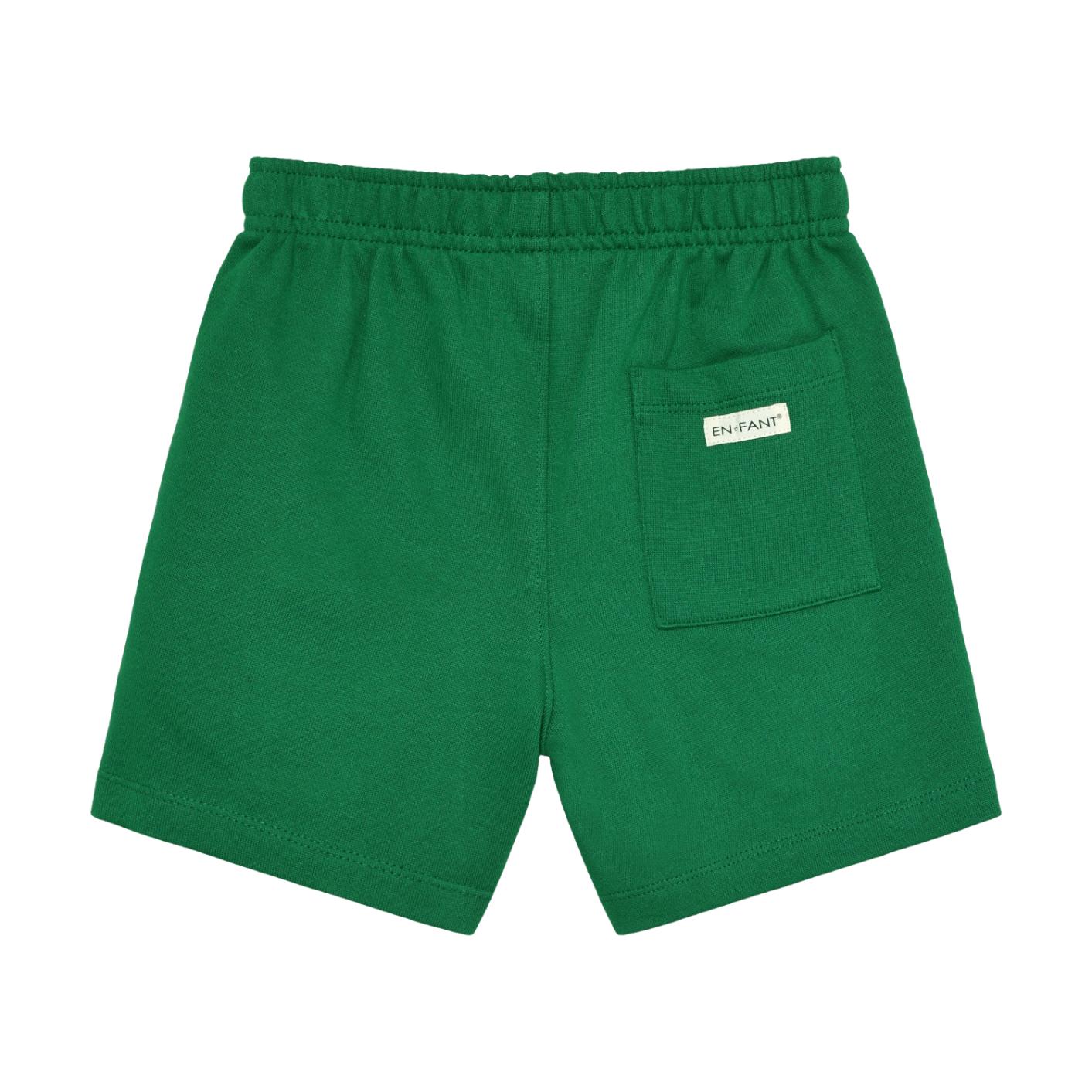 Green sweat shorts with an elasticated waistband and a back right patch pocket featuring a white "EN FANT" label.