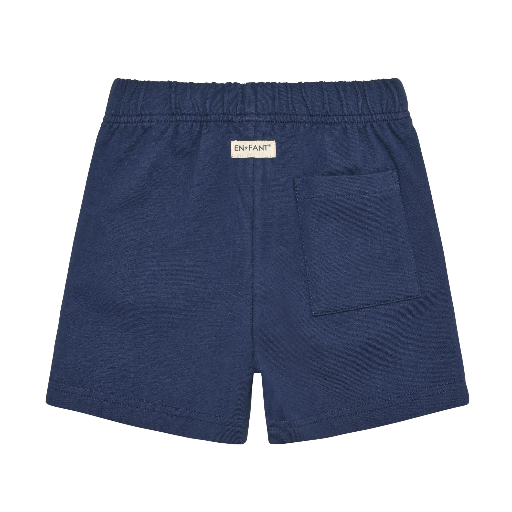 Muslin blue shorts with an elasticated waistband, a rear patch pocket on the right, and a small 'EN*FANT®' tag.