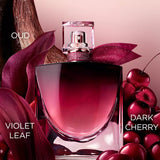 Clear glass perfume bottle with a cherry red gradient, a gold-toned sprayer, a sparkling red crystal collar, and a glittery r