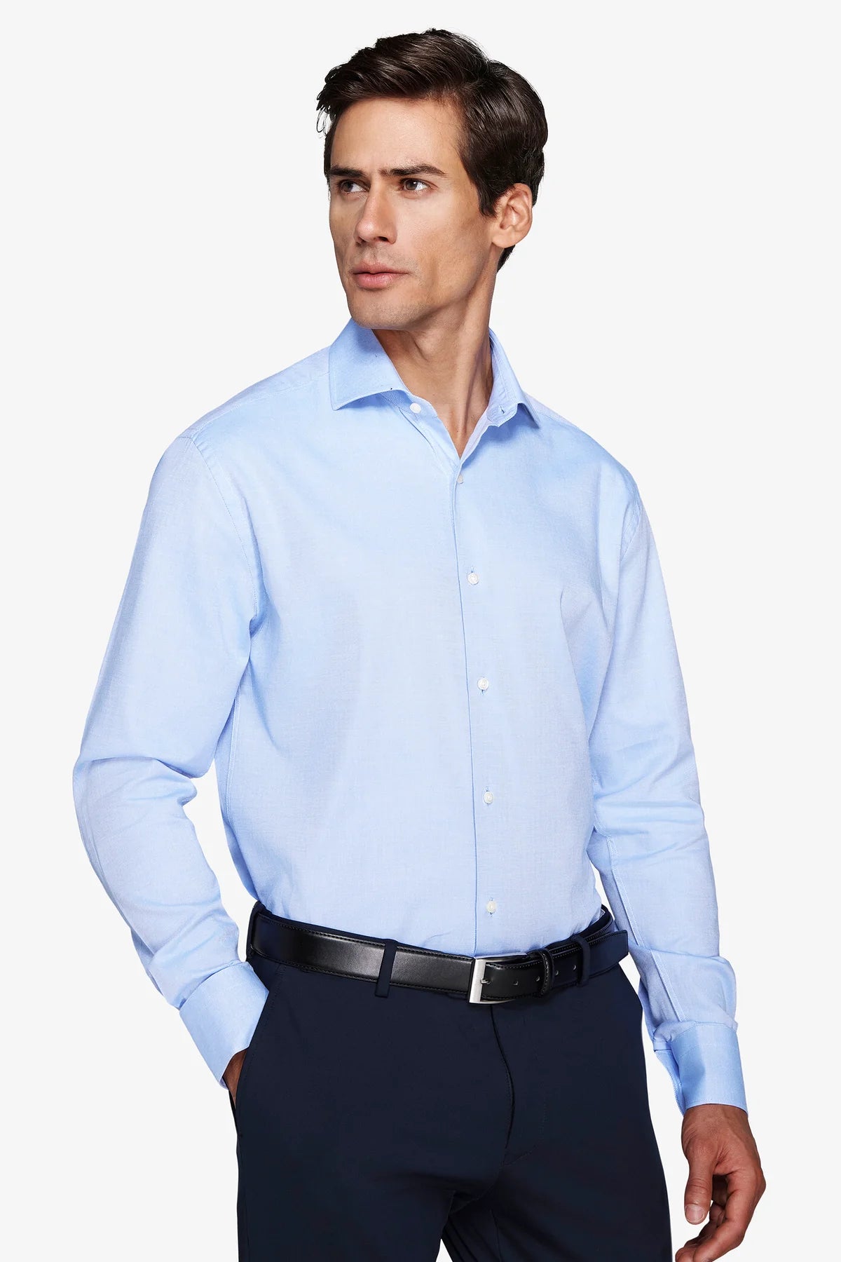 Light blue tailored long-sleeved shirt with a spread collar and white buttons down the front and on the cuffs.