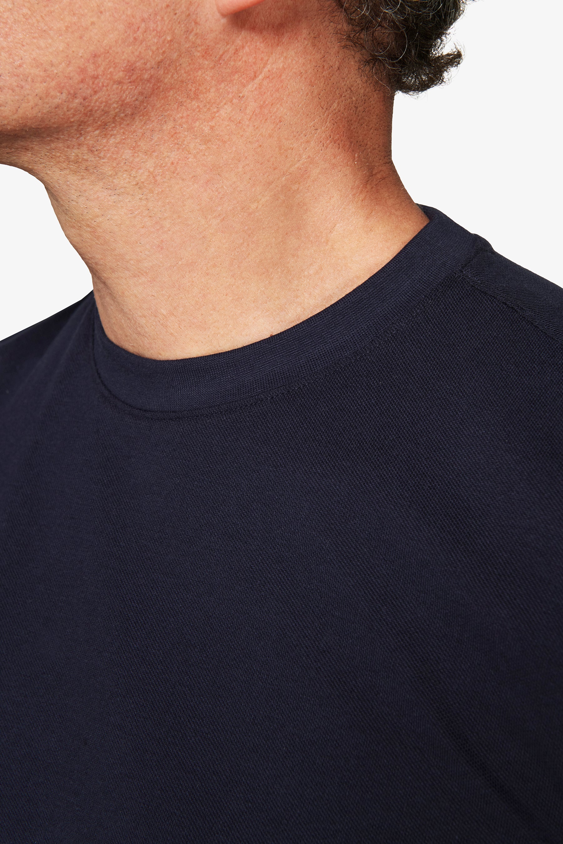 Navy blue crew neck t-shirt with a ribbed collar and short sleeves.