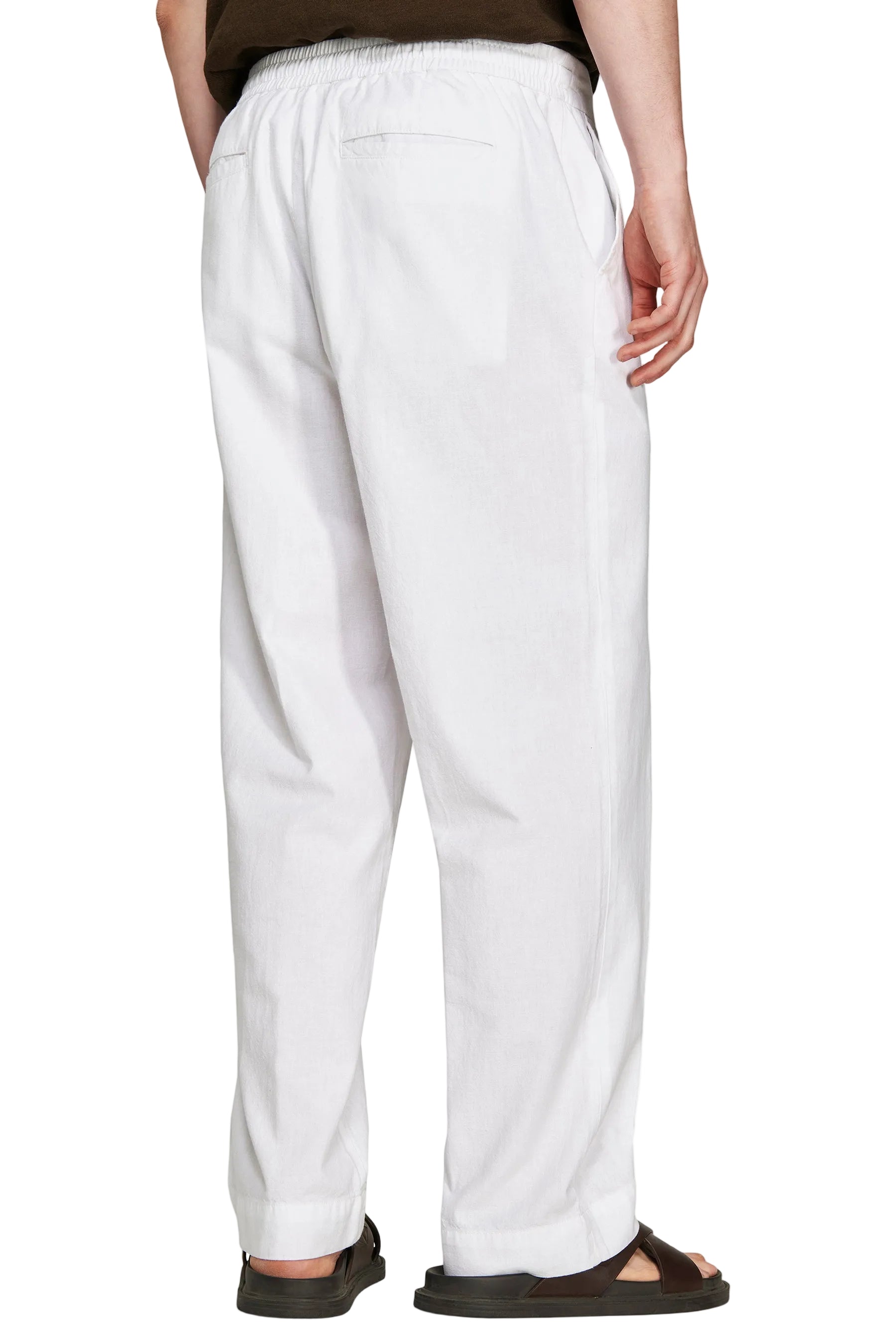 White linen blend relaxed fit trousers with an elasticated waist, two rear welt pockets, and side pockets.