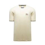 Light cream short-sleeved crew neck T-shirt with dark striped ribbed cuffs and an embroidered winged emblem on the chest.