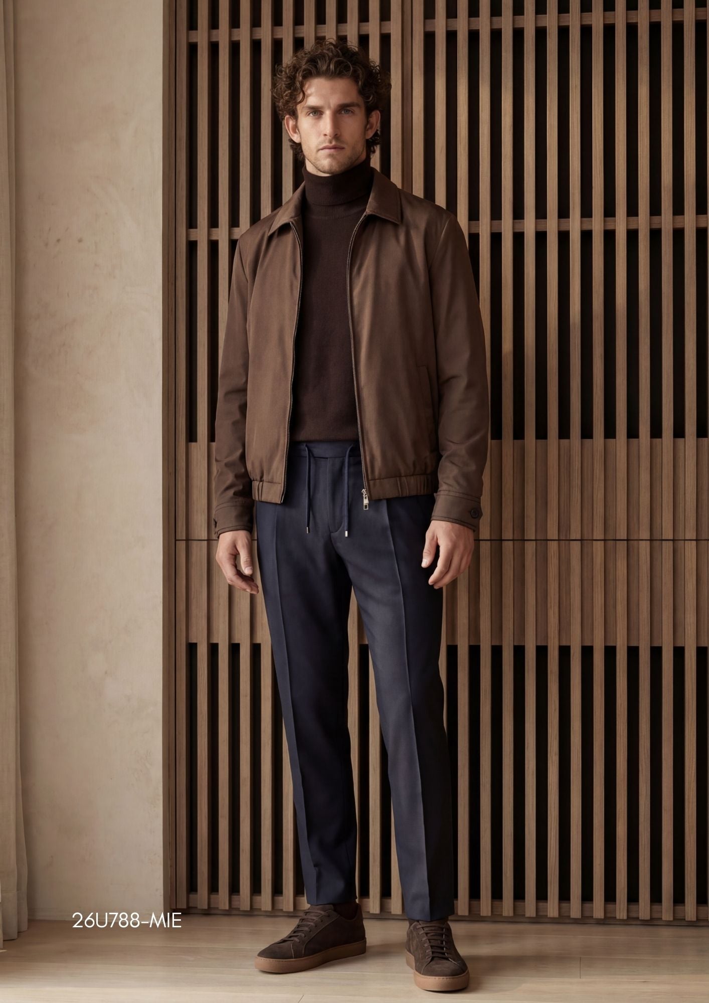 Smooth brown jacket with a pointed collar, silver-toned full-zip front, ribbed cuffs, and ribbed hem. Two subtle side pockets