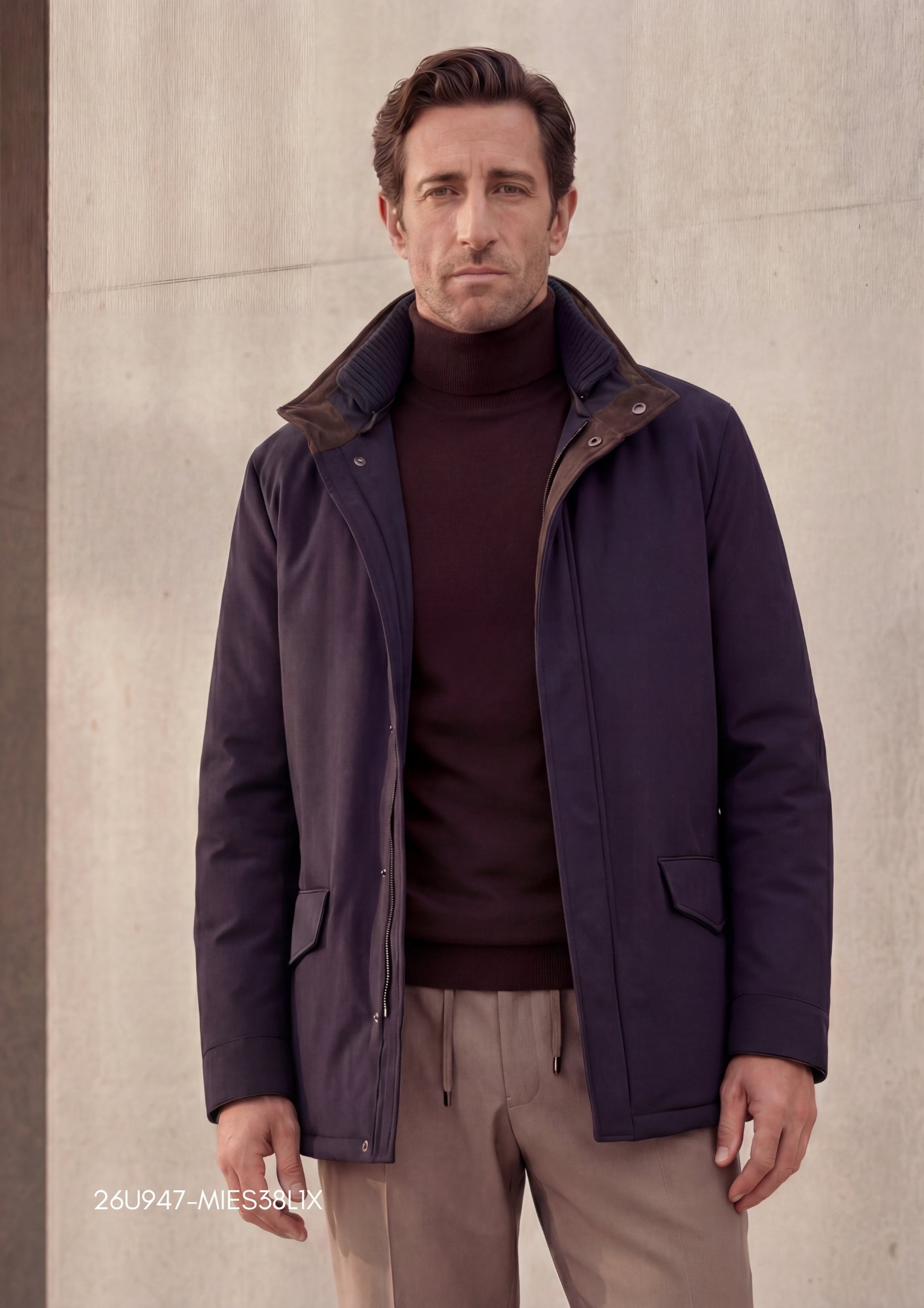 Dark blue jacket with a smooth fabric, ribbed inner collar, brown suede-like outer collar, front zipper, and two flap pockets
