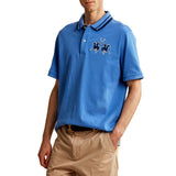 Blue pique knit polo shirt with a navy striped collar, two white buttons, and an embroidered navy polo players logo.