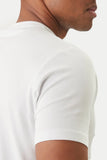 White crewneck t-shirt with short sleeves and a hemmed cuff.