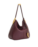 Burgundy hobo bag made of smooth material, featuring a single strap with gold-toned curved hardware and a matching horn-shape