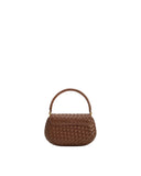 Brown hand-woven round top handle bag with a curved flap and gold-toned hardware connecting the handle.