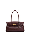 Structured shoulder bag in a deep burgundy colour, featuring a single top handle and gold-toned turn-lock closure.
