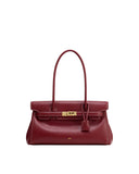 Burgundy leather shoulder bag with two top handles, a front flap, gold-toned turn-lock clasp, white contrast stitching, and a