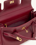 Deep red smooth leather shoulder bag with white contrast stitching. Features gold-toned turn-lock closure, front strap detail