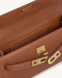 Deep burgundy textured top handle bag, open to show interior pocket. Features a gold-toned turn-lock closure with rectangular