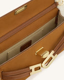 Tan suede-like structured handbag, open, with brown leather-like trim, white stitching, gold-toned hardware, and white fluffy