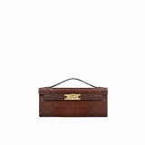 Brown crocodile-embossed structured top handbag with a single curved top handle, front flap, and gold-toned turn-lock clasp.