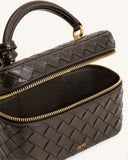 Dark brown woven box-shaped top handle bag with gold-toned zipper and hardware. Open, showing dark interior and JW PEI logo.