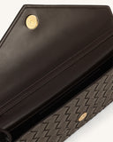 Dark brown woven textured envelope bag with smooth interior flap and gold-toned magnetic snap closure.