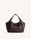 Dark brown pebbled faux leather tote bag with a softly gathered top, central horizontal band, and two matching top handles.