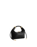 Black pebbled top-handle bag with a rounded handle, two large gold-toned rings, a gold-toned zipper, and two black drawstring