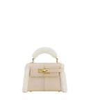 Taupe faux suede top handle bag with cream shearling trim on sides and handle, featuring a gold-toned turn-lock closure.