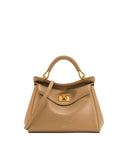 Light brown faux leather top handle bag with a rounded handle, gold-toned hardware, a front flap, and a rectangular turn-lock