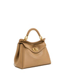 Tan faux leather top handle bag with a structured shape, front flap, gold-toned turn-lock closure, and a single curved handle