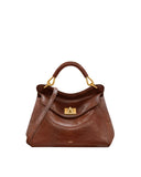 Brown faux leather top handle bag with a front flap, gold-toned turn-lock clasp, and a thin shoulder strap. Curved top handle