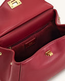 Open red faux leather top handle bag with gold-toned turn-lock. Faux suede interior, zipper pocket, and 'JW PEI' logo patch.