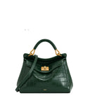 Dark green crocodile-embossed faux leather top handle bag with a single top handle, detachable shoulder strap, and gold-toned