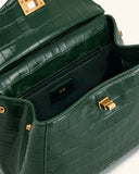 Open dark green faux crocodile-embossed top handle bag with gold-toned turn-lock closure, interior zipper pocket, and 'JW PEI