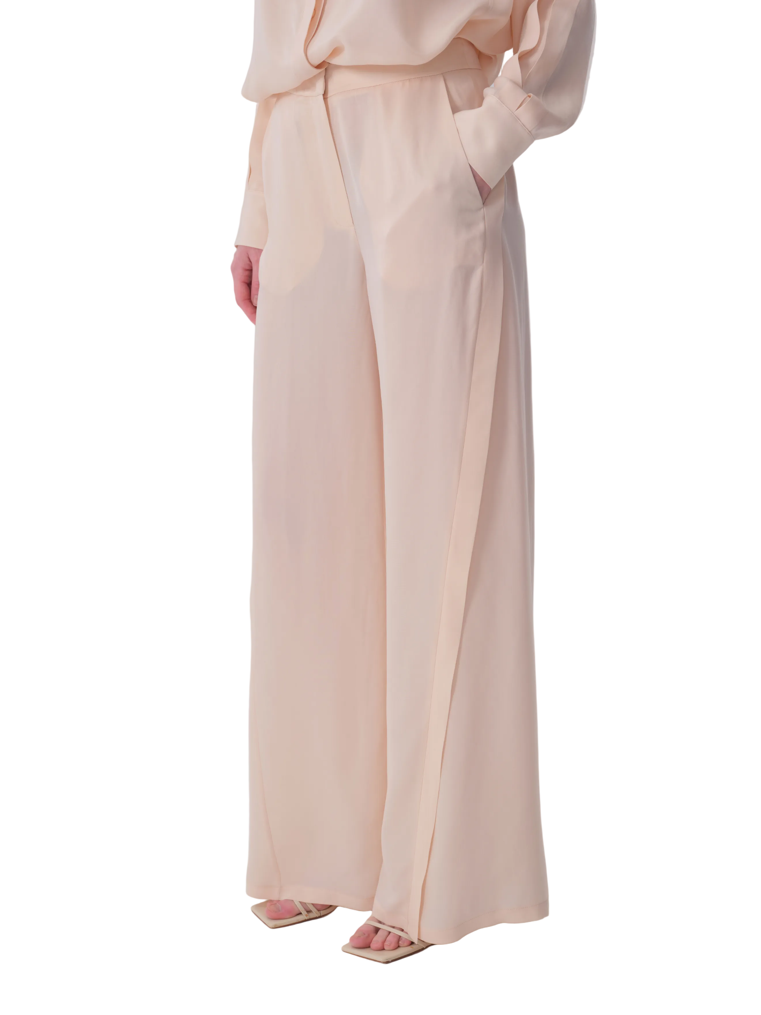 Light beige wide-leg trousers with side pockets and a vertical panel detail on the outer leg