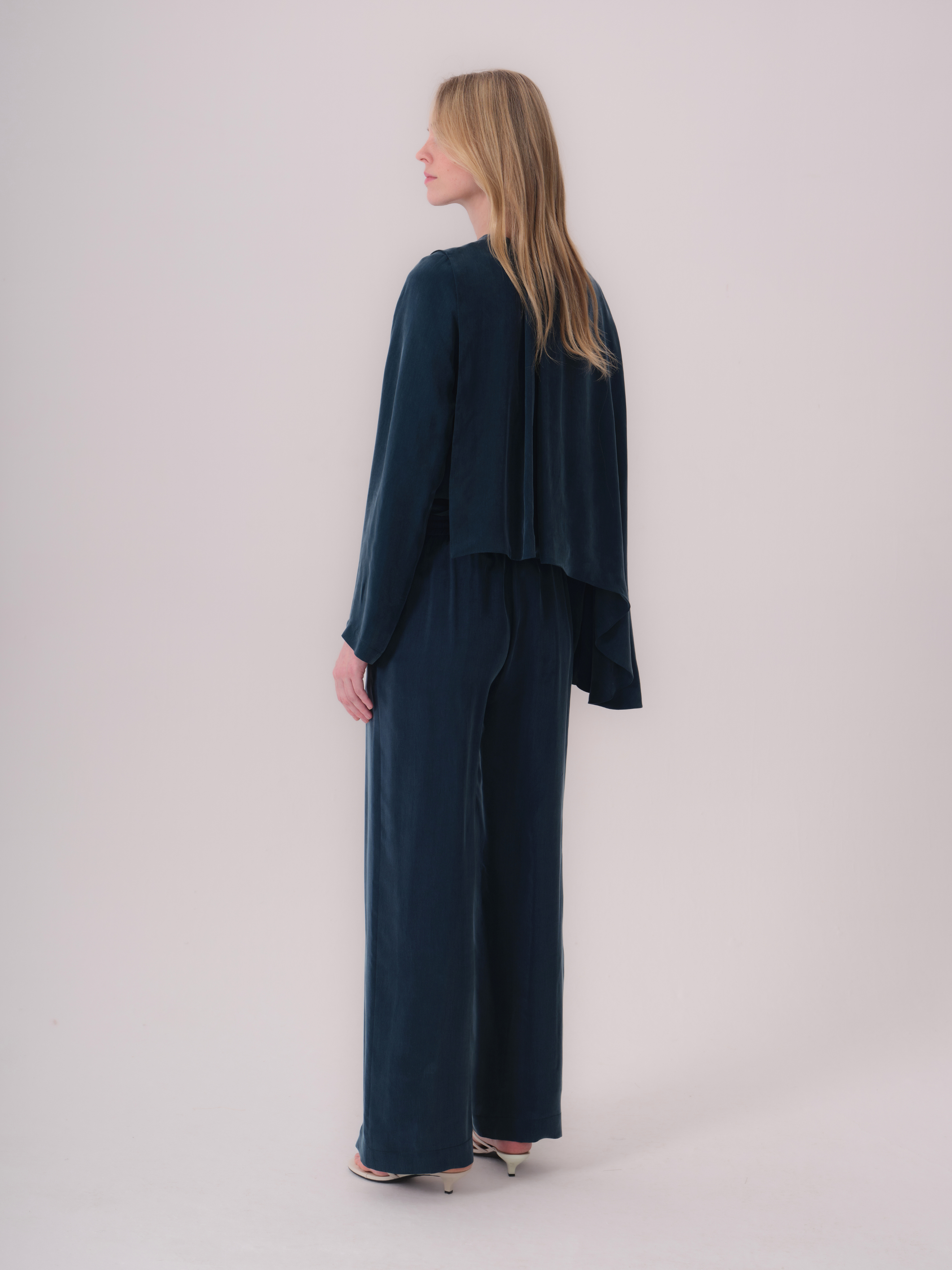 Petroleum wide-leg trousers in a smooth, flowing fabric, with a full-length hem.