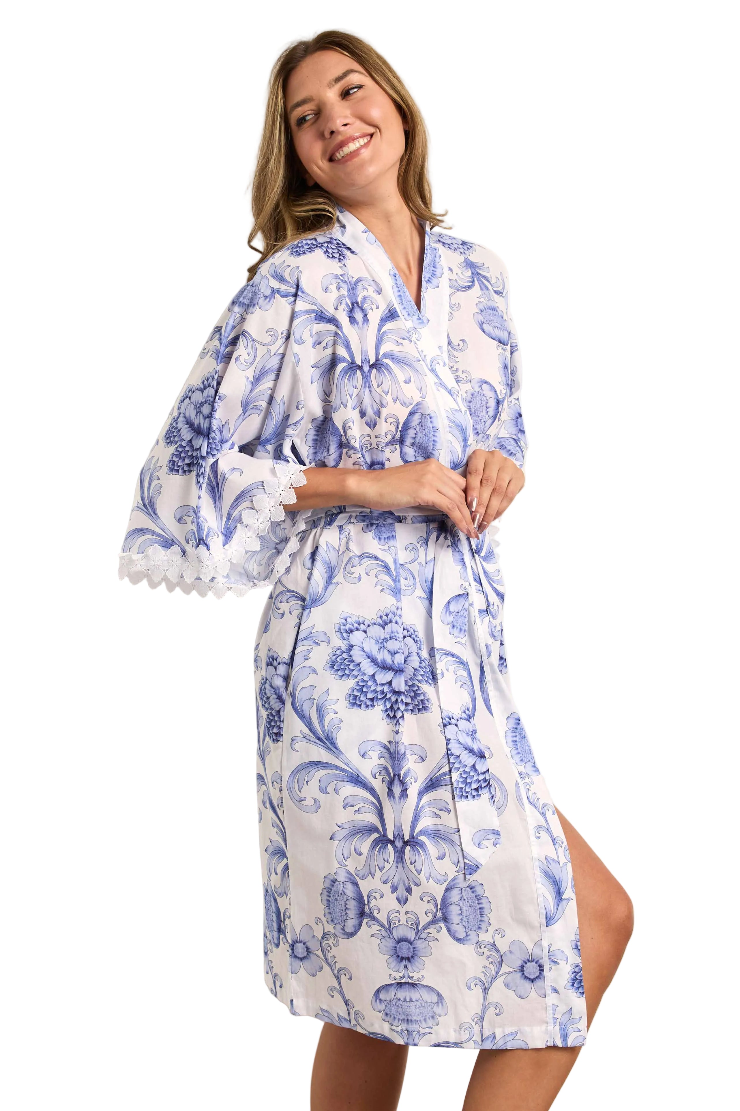 White kimono wrapover with blue floral and scrollwork pattern, wide three-quarter sleeves with white lace trim, and a self-ti