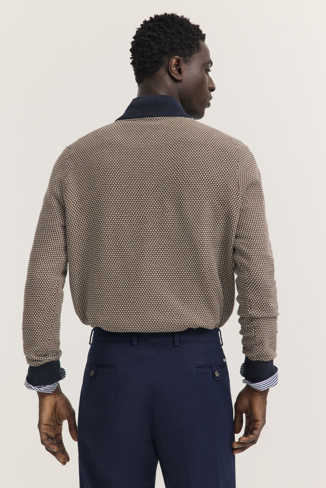 Brown and dark blue textured knit sweater with a navy polo collar and ribbed cuffs.