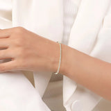 Gold-toned tennis bracelet with a continuous line of clear, round stones.