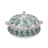 Casa Blu insulated serving casserole dish featuring a teal and white Lily of the Valley floral pattern with polished chrome handles and lid knob.