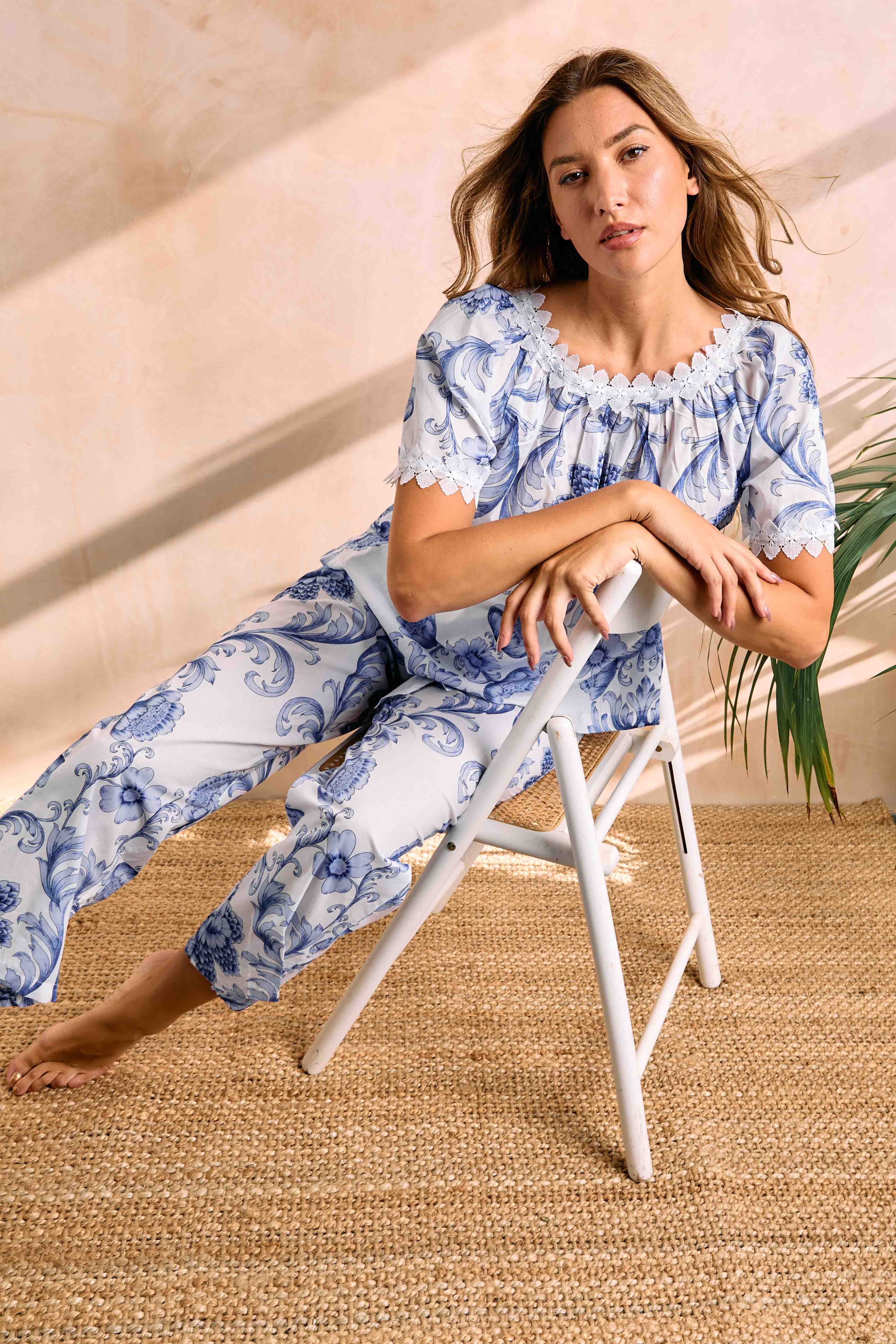 White and ChinaBlue floral pajama set. Short-sleeve top with gathered, lace-trimmed neckline. Pants have elasticated cuffs.