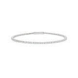 Silver-toned flexible tennis bracelet with a single row of clear, round stones and a flat bar clasp.