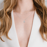 Silver-toned chain necklace with an Asscher-cut clear stone pendant in a four-prong setting.