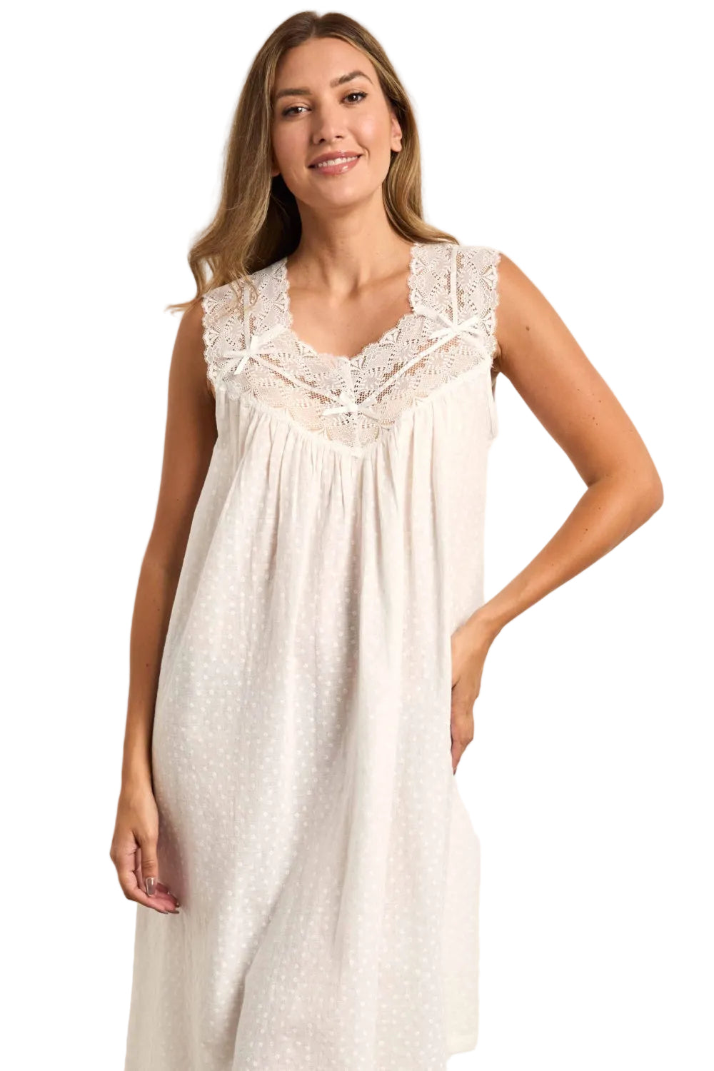 Cream sleeveless nightdress with embossed dot pattern and lace-trimmed V-neck with ribbon details.