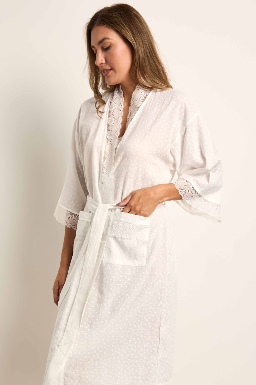 Cream kimono robe with embossed dots, lace trim on lapels and 3/4 sleeves, a matching waist tie, and a lace-trimmed patch poc