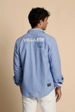 Chambray blue long-sleeved shirt with 'PLAYER CAPTAIN POLO PLAYER ARGENTINA 03' text on the back. Striped inner collar and cu