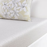 Pillow with light green ground, white and grey floral print, grey piping. Light grey and off-white speckled textured flat she