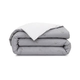 Folded duvet cover with light gray vertical stripes and repeating 'BB' monograms. Reverse side is white with thin gray stripe